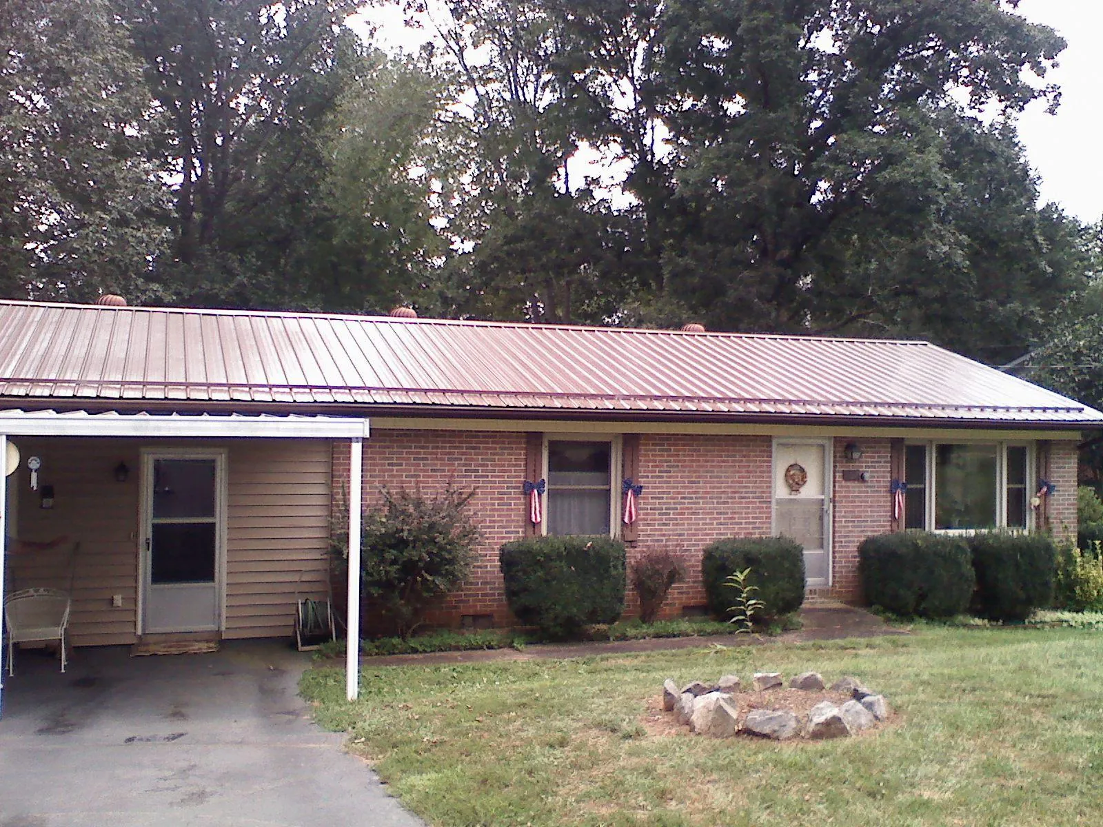 Bronze metal roof and carport on a brick ranch home — Roof Repair work by our crew in Aberdeen Proving Ground