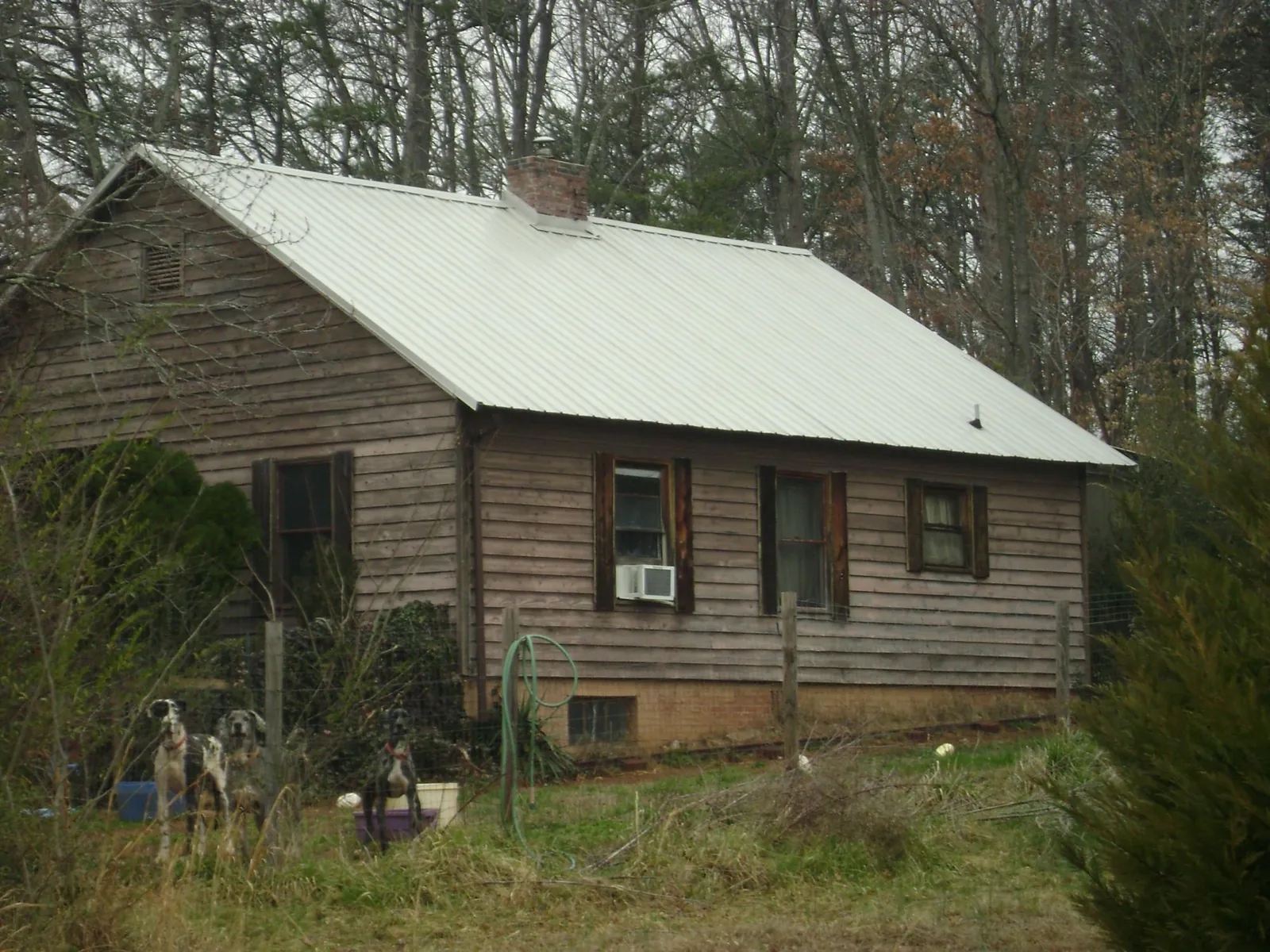 White metal roof on an old wood sided farmhouse, from a Metal Roof Installation job in Aberdeen Proving Ground